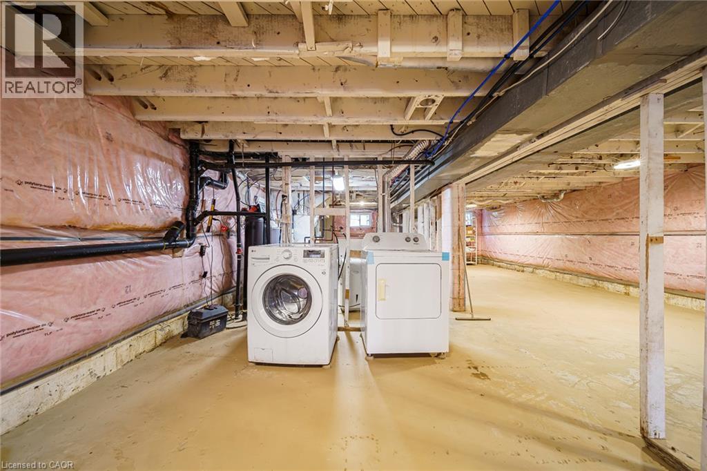 Unfinished basement offering expansive open space, exposed ceiling joists, and visible insulation along perimeter walls - 7332 Twenty Road E, Glanbrook, ON - Indoor Photo Showing Laundry Room