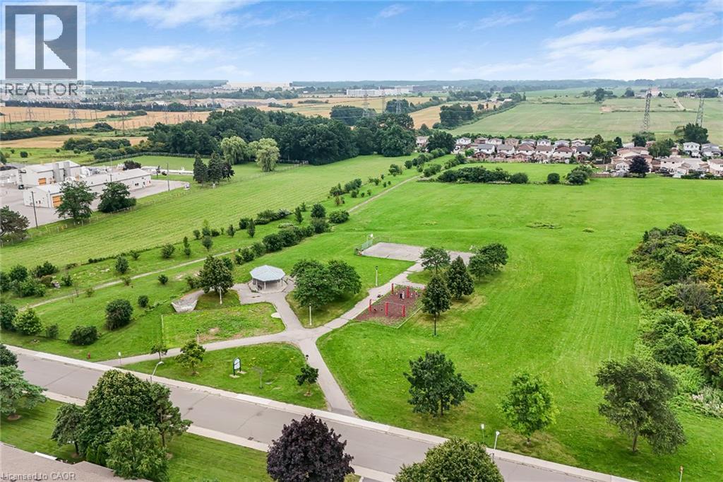 Expansive green spaces featuring walking paths, mature trees, and a shaded gazebo - 7332 Twenty Road E, Glanbrook, ON - Outdoor With View