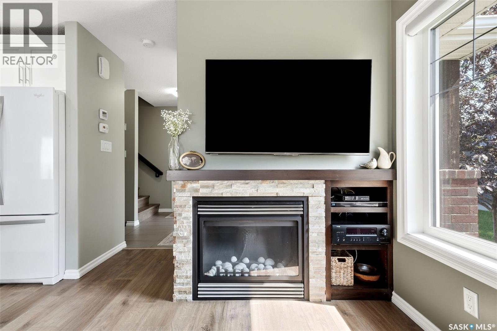 213 4002 Sandhill Crescent, Regina, SK - Indoor Photo Showing Living Room With Fireplace
