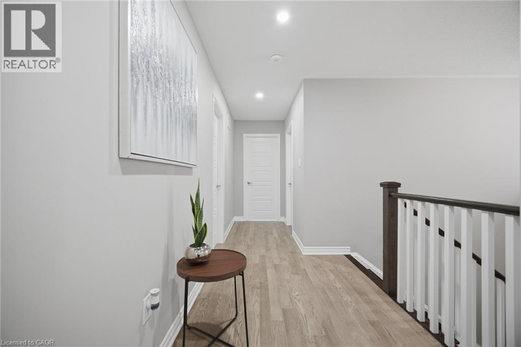 Hallway featuring light-toned wood-finish flooring, recessed lighting, white baseboards, and interior doors - 542 Boyd Lane, Milton, ON - Indoor Photo Showing Other Room