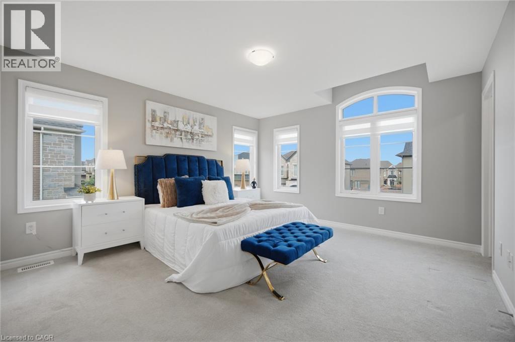Spacious room featuring light gray wall paint and light-colored carpeting - 542 Boyd Lane, Milton, ON - Indoor Photo Showing Bedroom