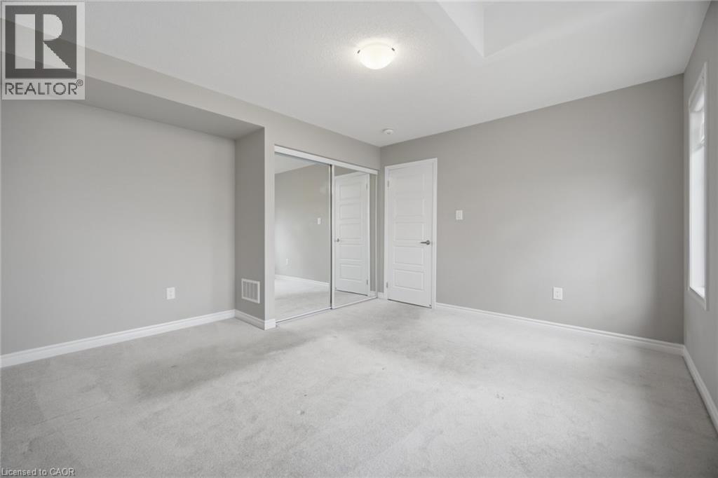 Carpeted room with light gray walls, white baseboards, and a white ceiling - 542 Boyd Lane, Milton, ON - Indoor Photo Showing Other Room