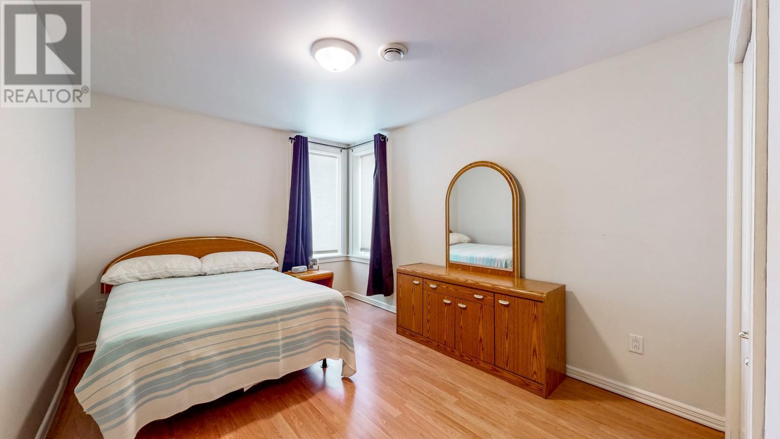 APT. bedroom corner windows - 28 Pinware Crescent, Mount Pearl, NL - Indoor Photo Showing Bedroom