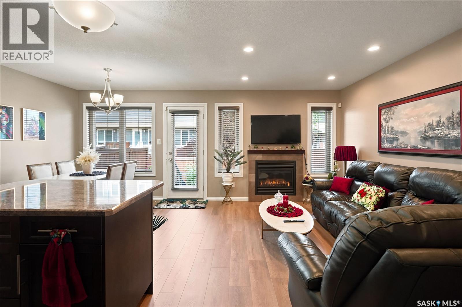 104 4100 Sandhill Crescent, Regina, SK - Indoor Photo Showing Living Room With Fireplace