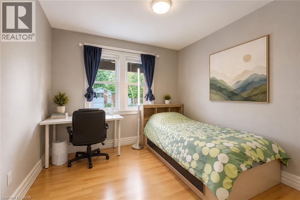 Bright room featuring light wood-finish flooring, neutral painted walls, and white trim - 74 Royal Avenue, Hamilton, ON - Indoor Photo Showing Bedroom