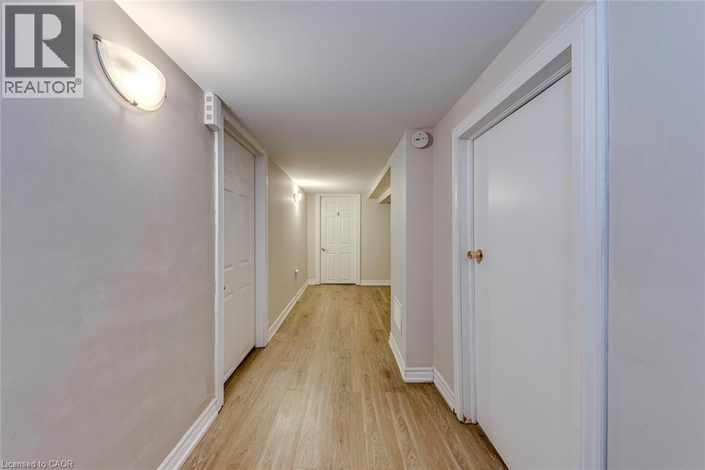 Hallway with wood-finish flooring and light-toned walls - 74 Royal Avenue, Hamilton, ON - Indoor Photo Showing Other Room