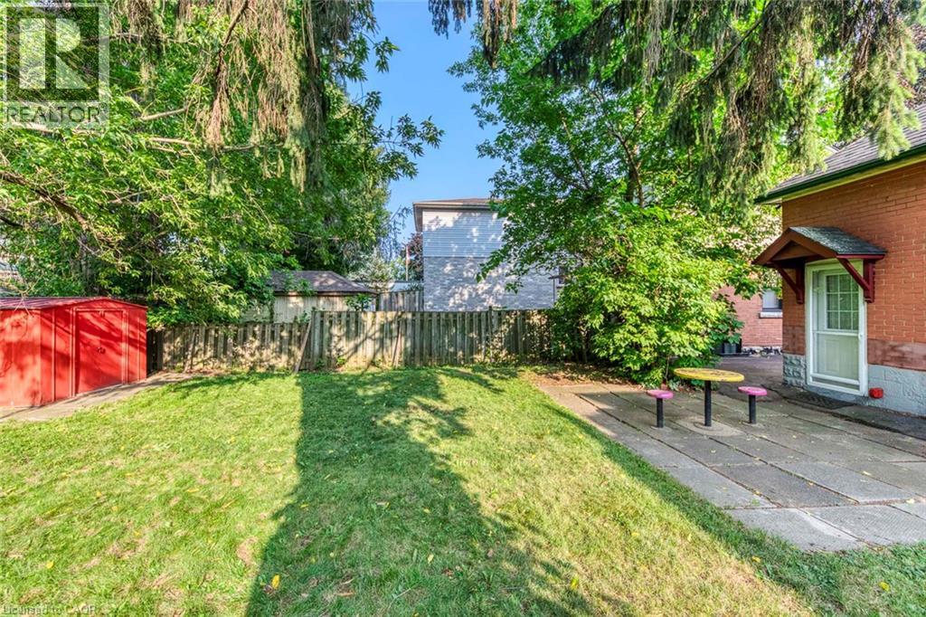 Expansive rear yard featuring a manicured lawn, perimeter fencing, and mature trees - 74 Royal Avenue, Hamilton, ON - Outdoor
