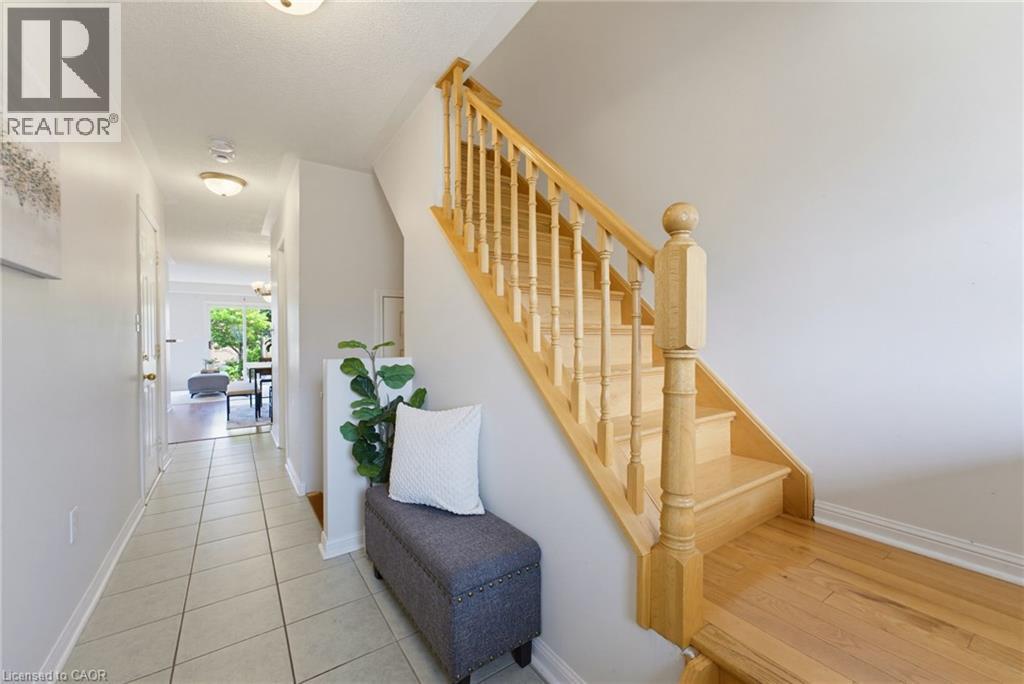 Light wood staircase featuring balusters and a polished handrail - 4425 Peter Drive, Burlington, ON - Indoor Photo Showing Other Room