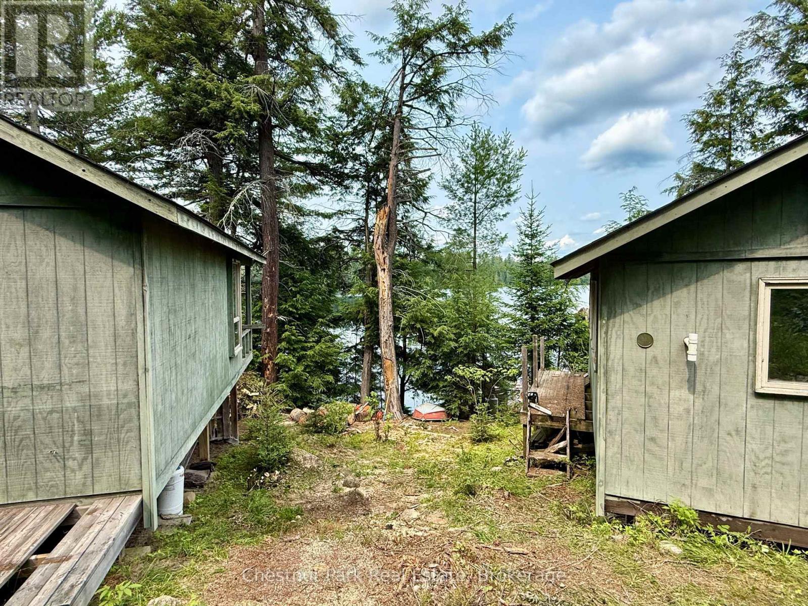 Bunkie and main cottage looking towards the lake - 50 Cache Lake Apl1322, South Algonquin, ON - Outdoor
