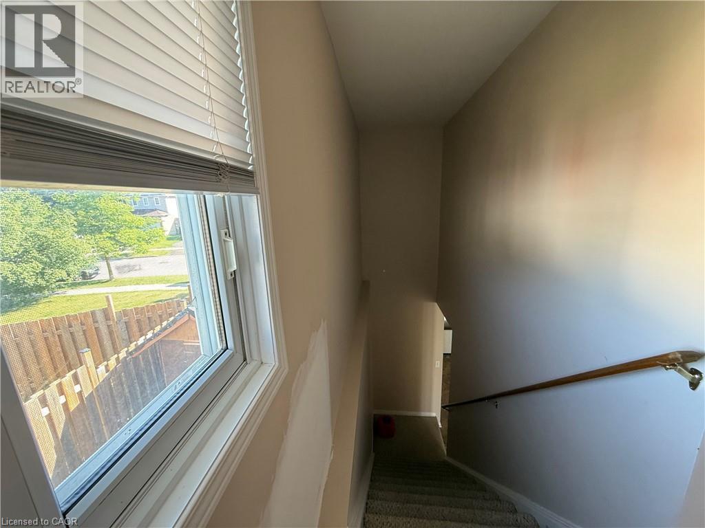Stairwell with neutral wall tones and carpeted steps - 11 Hackberry Street Unit# 1, Kitchener, ON - Indoor Photo Showing Other Room