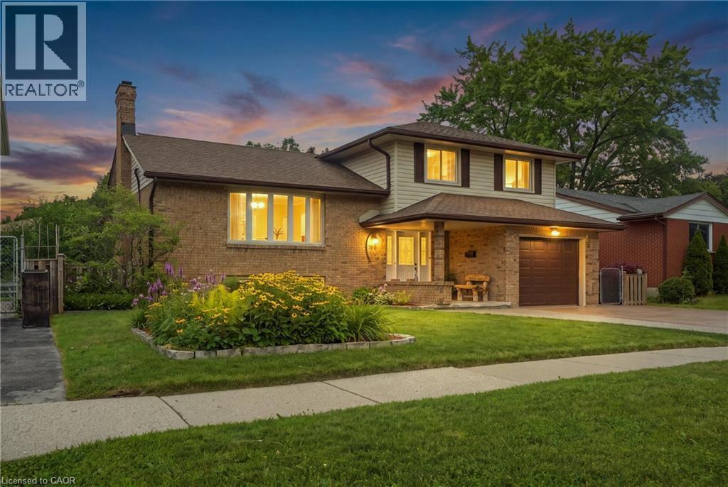 Brick and siding exterior featuring a covered entry, an attached garage, and a bay window - 76 Lower Canada Crescent, Kitchener, ON - Outdoor