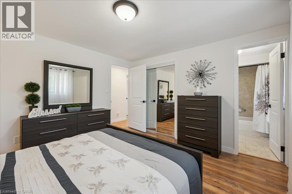 Bedroom featuring wood-finish flooring, a flush-mount ceiling light, and white walls - 76 Lower Canada Crescent, Kitchener, ON - Indoor Photo Showing Bedroom