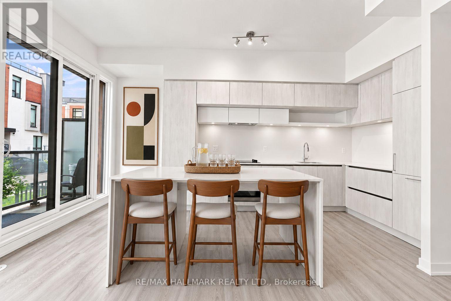 Kitchen Area with Island Bar and Balcony Access - 1508 - 11 David Eyer Road, Richmond Hill, ON - Indoor