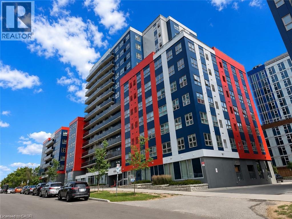Modern high-rise building featuring a striking red, blue, and white facade - 258B Sunview Street Unit# 255, Waterloo, ON - Outdoor
