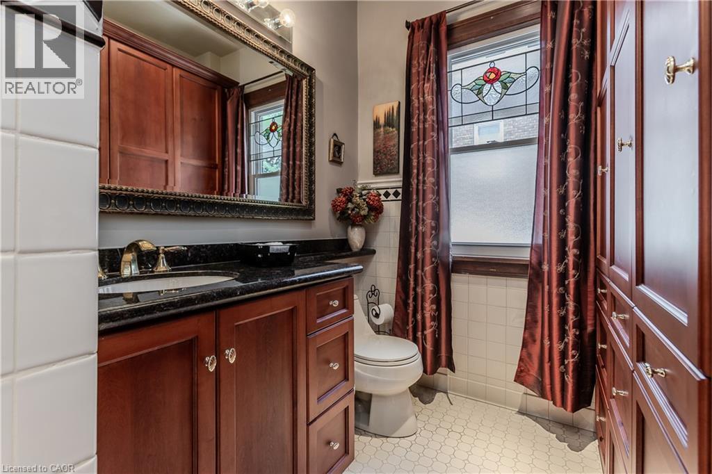 Cherry wood-finish cabinetry and built-in storage - 569 Locust Street, Burlington, ON - Indoor Photo Showing Bathroom