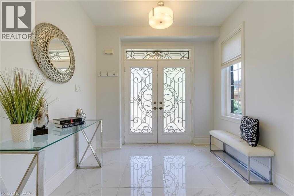 Entryway featuring double doors with decorative wrought iron detailing and a transom window above - 2380 Woodcrest Drive, Oakville, ON - Indoor Photo Showing Other Room