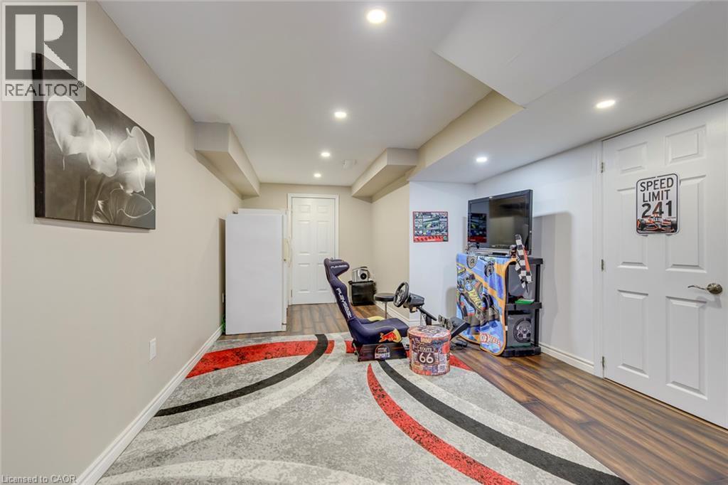 Recessed lighting illuminates the space, featuring wood-finish flooring and two paneled doors - 2380 Woodcrest Drive, Oakville, ON - Indoor Photo Showing Gym Room