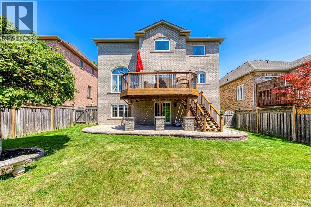 Rear exterior featuring a brick facade and a two-level deck with wooden railings and stairs - 2380 Woodcrest Drive, Oakville, ON - Outdoor With Deck Patio Veranda