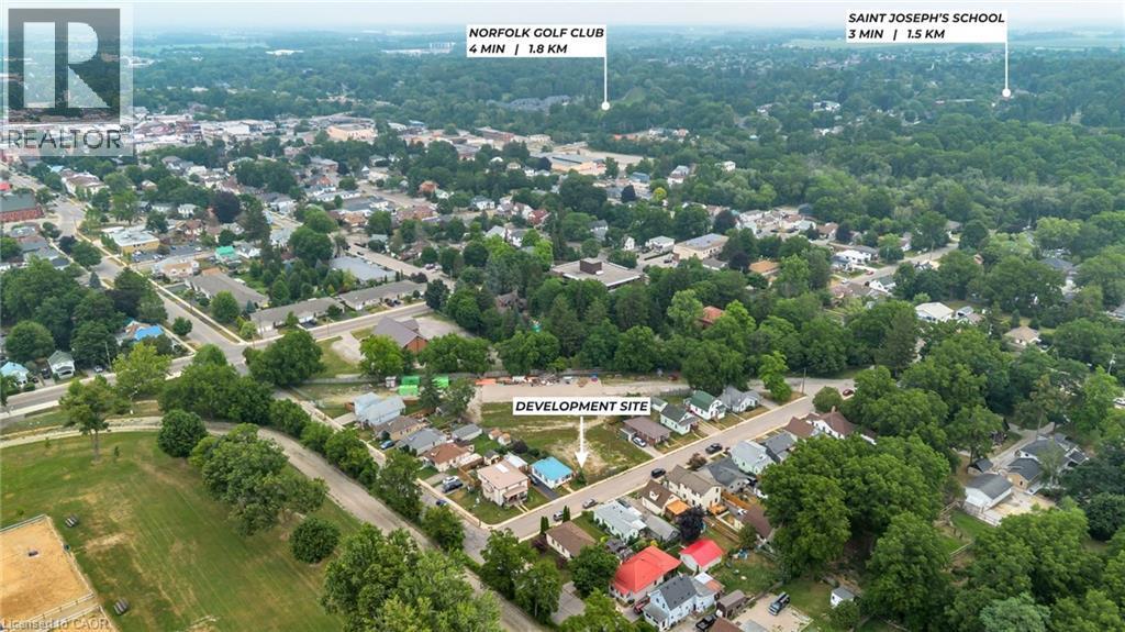 Aerial perspective showcasing the development site within a residential area featuring established homes and mature trees - 7 James Street, Simcoe, ON