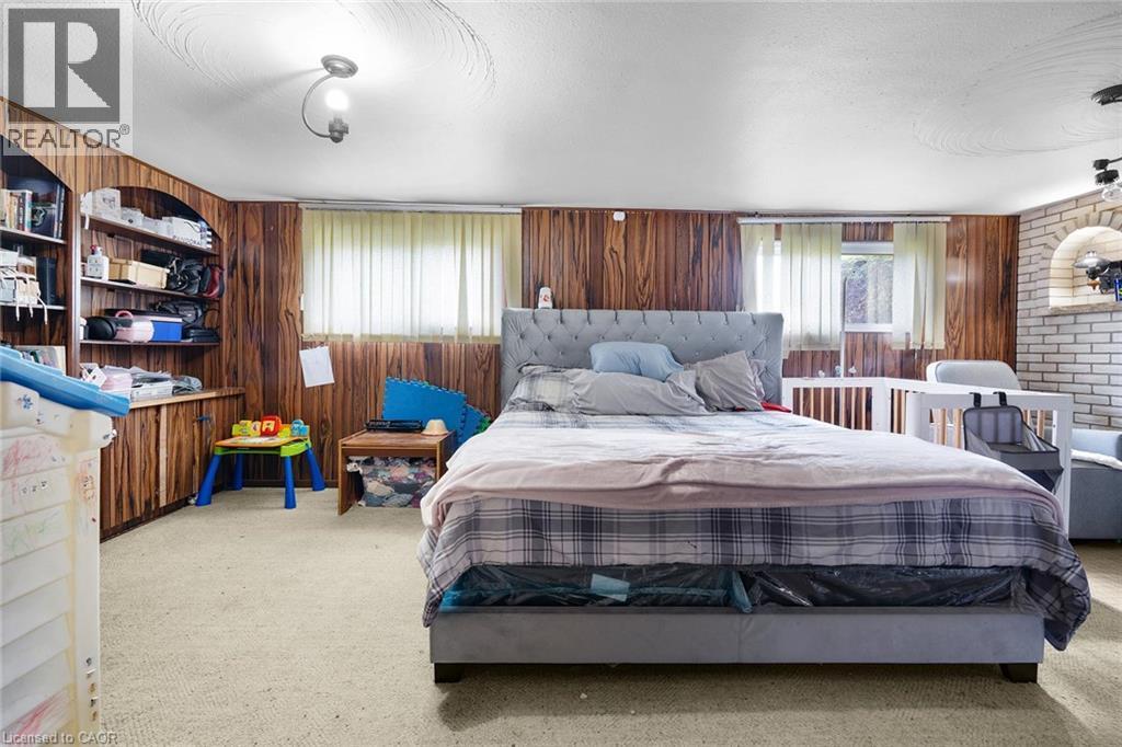 LOWER LEVEL REC ROOM CURRENTLY USED BY TENANTS AS A BEDROOM W/FIREPLACE - 591 Mohawk Road W, Hamilton, ON - Indoor Photo Showing Bedroom