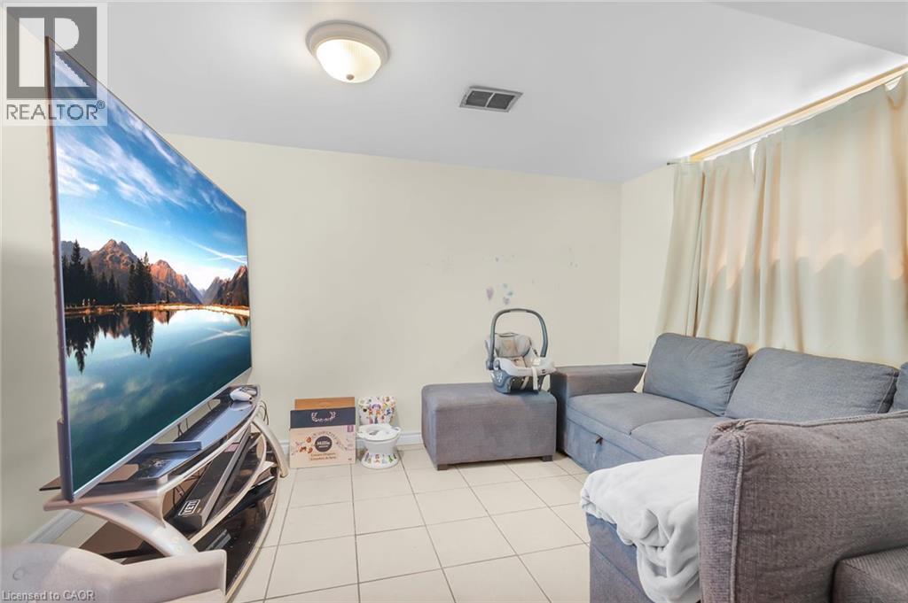 LOWER LEVEL BEDROOM CURRENTLY USED AS A LIVING ROOM/TV ROOM - 591 Mohawk Road W, Hamilton, ON - Indoor
