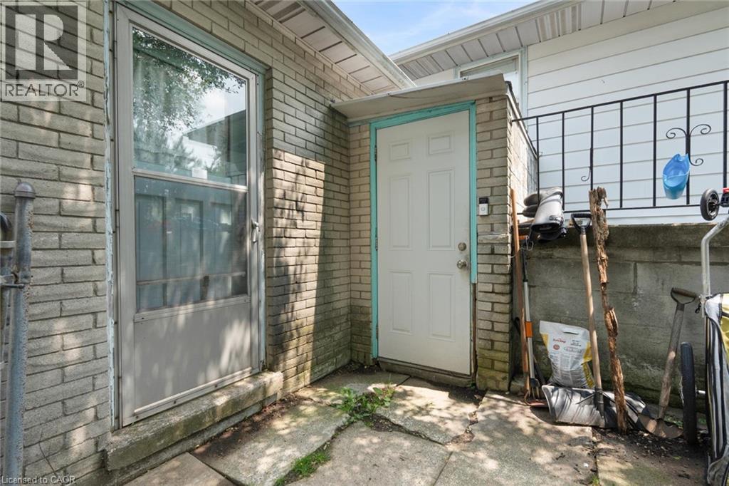 BASEMENT LEVEL ENTRANCE FOR TENANTS AND DOOR FROM MAIN LEVEL TO REAR YARD - 591 Mohawk Road W, Hamilton, ON - Outdoor With Exterior