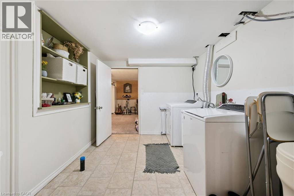 Laundry area featuring tile flooring and built-in shelving - 589 Elgin Street N, Cambridge, ON - Indoor Photo Showing Laundry Room