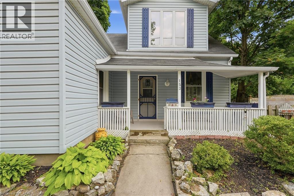 Light blue vinyl siding exterior with a covered front porch featuring white railings - 153 Montrose Street N, Cambridge, ON - Outdoor With Deck Patio Veranda With Exterior