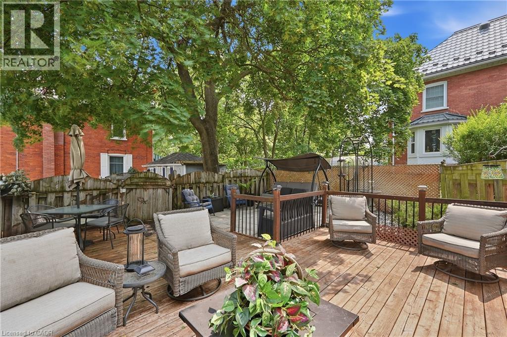 Expansive wood deck with dark wood railings and an integrated swing structure - 153 Montrose Street N, Cambridge, ON - Outdoor With Deck Patio Veranda With Exterior