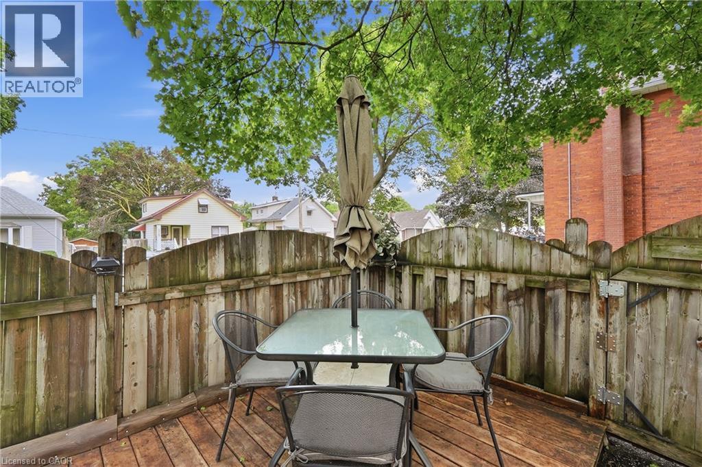 Wood-finish decking with a surrounding privacy fence and mature trees providing natural shade - 153 Montrose Street N, Cambridge, ON - Outdoor With Deck Patio Veranda With Exterior