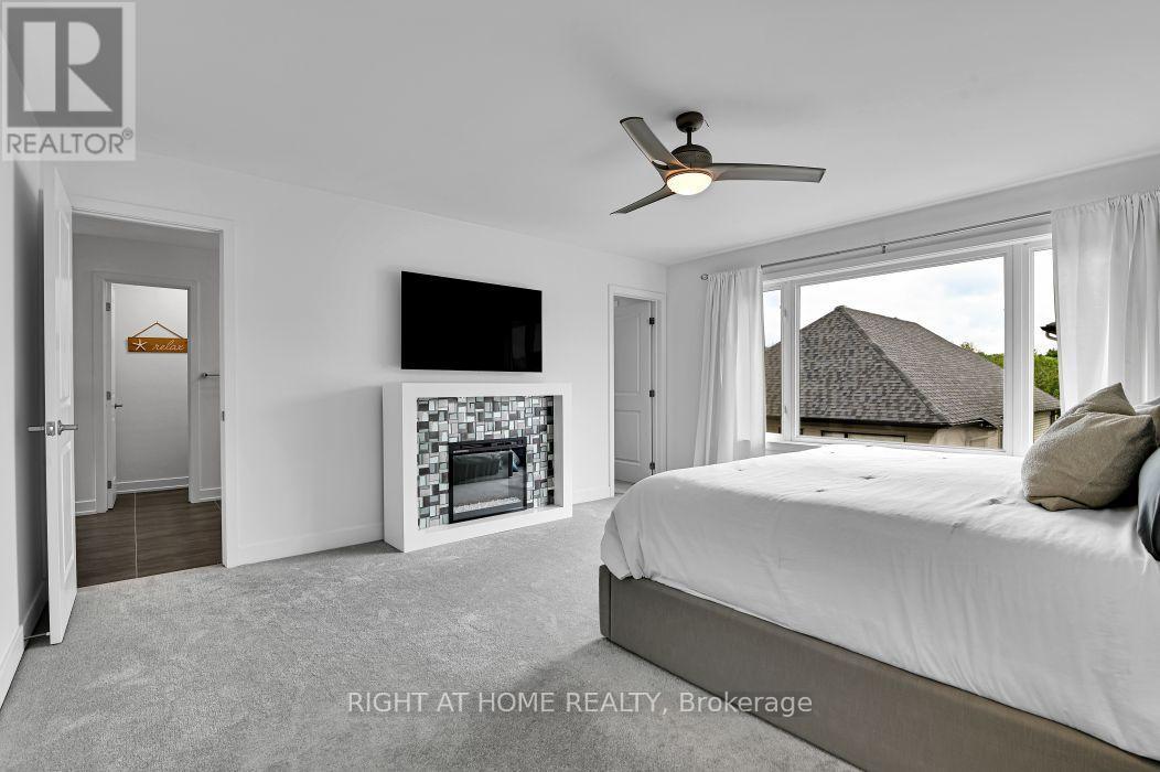 32 Edenbridge Court, Ottawa, ON - Indoor Photo Showing Bedroom With Fireplace