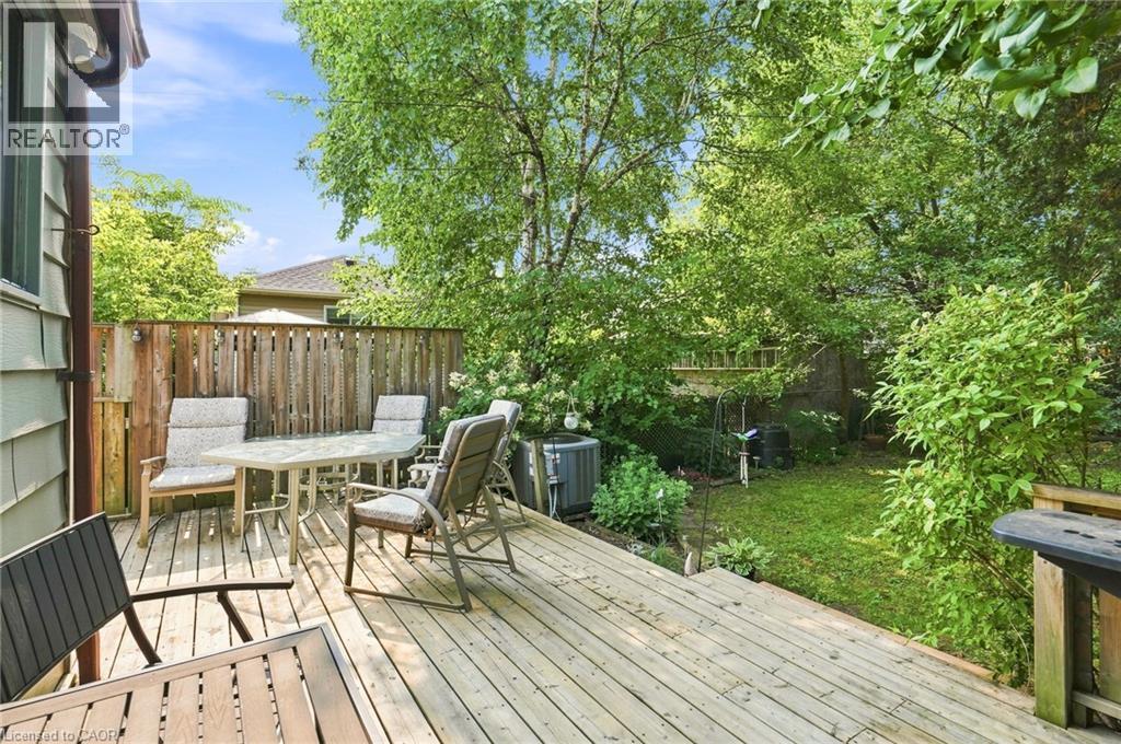 Wood-finish deck with a privacy fence, mature trees, and a grassy area - 58 Edinburgh Avenue, Hamilton, ON - Outdoor With Deck Patio Veranda With Exterior