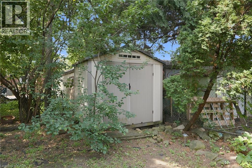 Outdoor storage shed featuring double doors and an upper transom window - 58 Edinburgh Avenue, Hamilton, ON - Outdoor