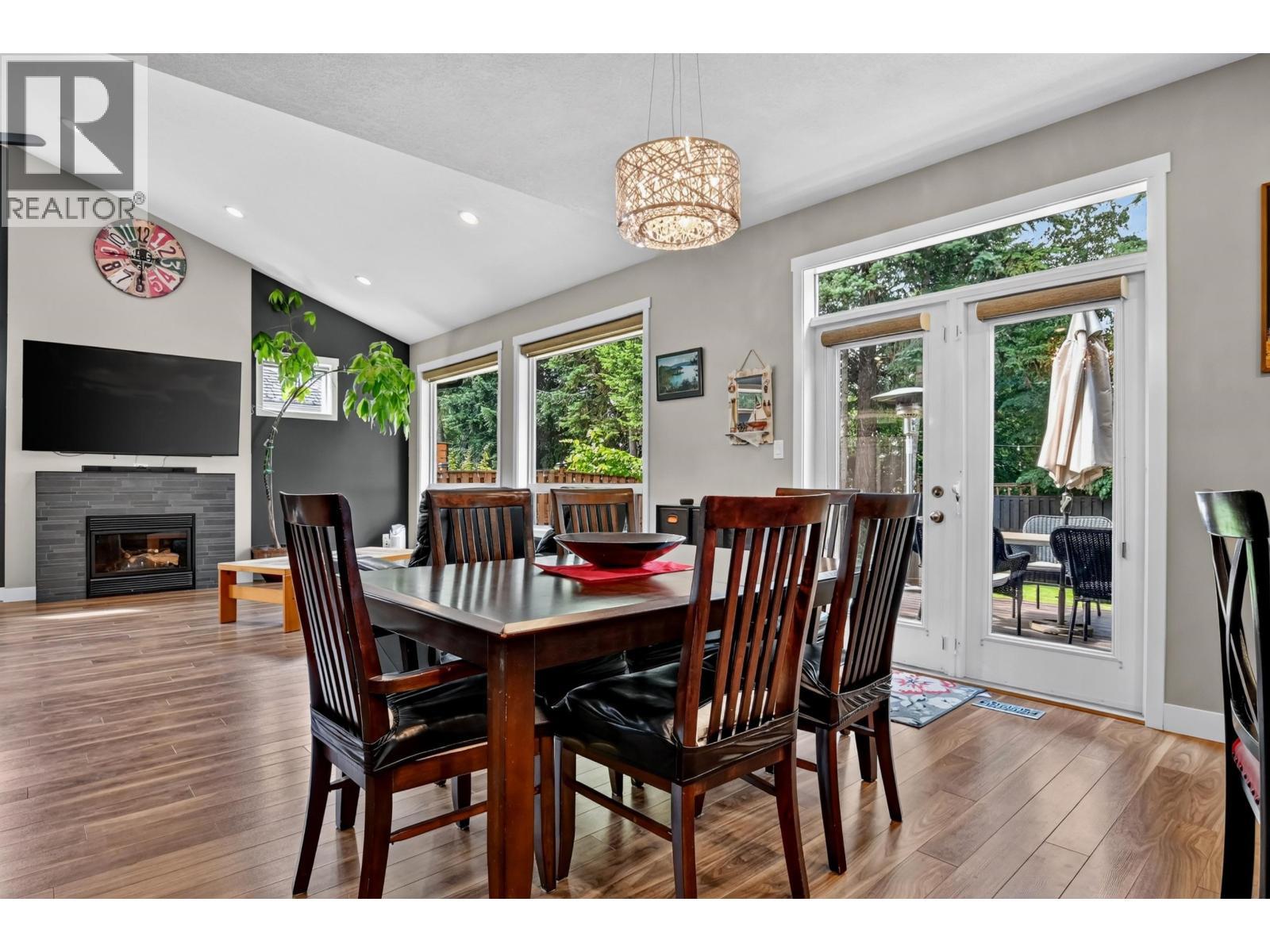 7557 Loedel Crescent, Prince George, BC - Indoor Photo Showing Dining Room With Fireplace