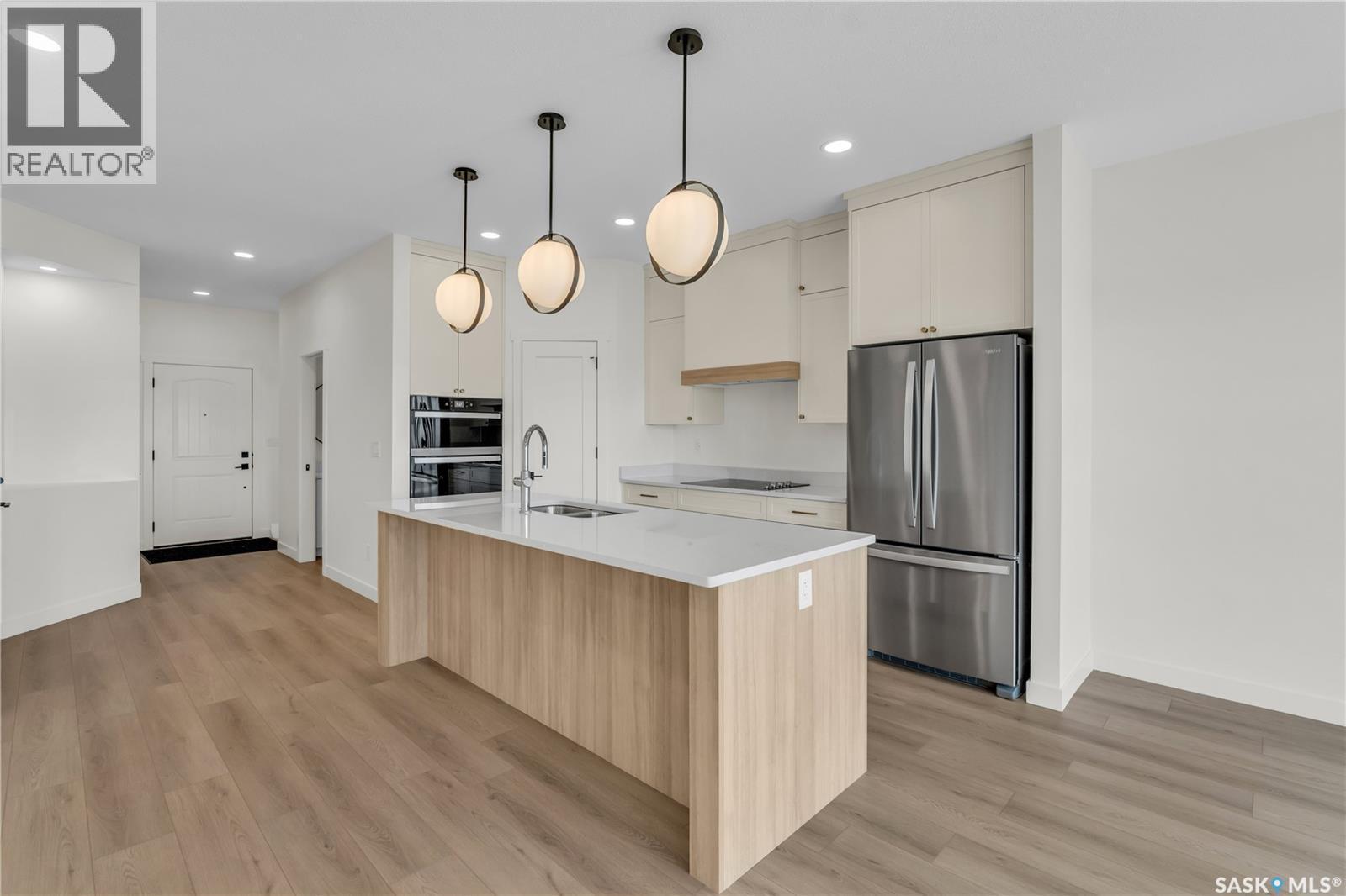 10 720 Brighton Boulevard, Saskatoon, SK - Indoor Photo Showing Kitchen With Double Sink
