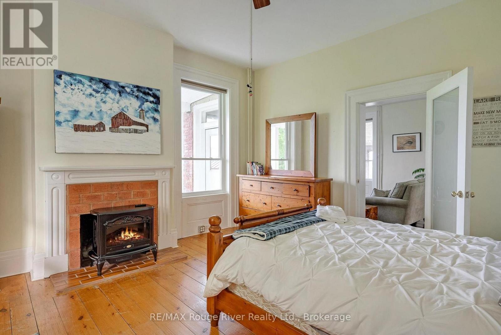 733 County Rd 2 Rd Road E, Otonabee-South Monaghan, ON - Indoor Photo Showing Bedroom With Fireplace