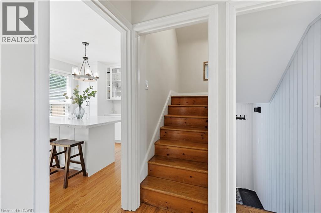 Hardwood staircase and plank-paneled wall detail - 18 Ipswich Place, Hamilton, ON - Indoor Photo Showing Other Room