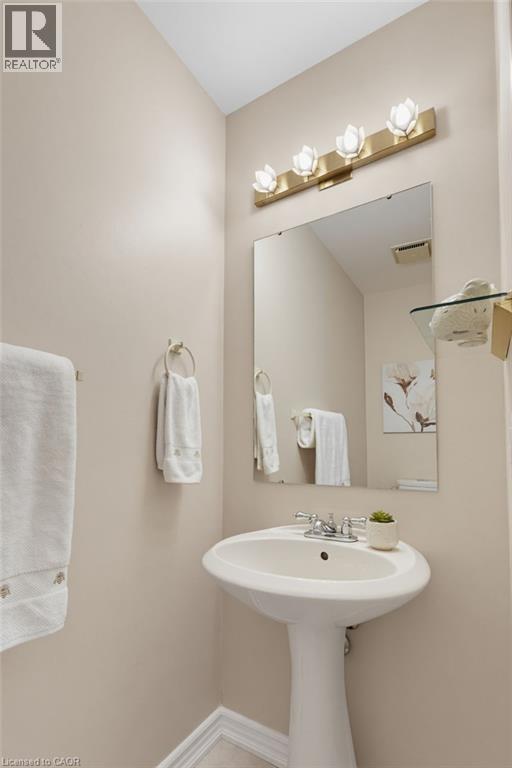 Pedestal sink with chrome fixtures, mirror, glass shelving - 2188 Bader Crescent, Burlington, ON - Indoor Photo Showing Bathroom
