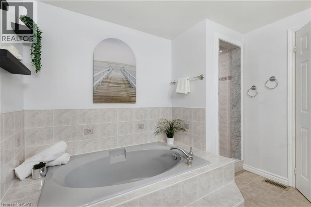 Built-in tub with tile surround and deck-mounted faucet, separate shower - 2188 Bader Crescent, Burlington, ON - Indoor Photo Showing Bathroom