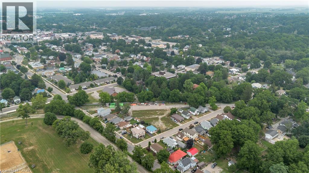 Aerial overview of a residential area characterized by mature tree cover and a mix of housing styles - 9 James Street, Simcoe, ON