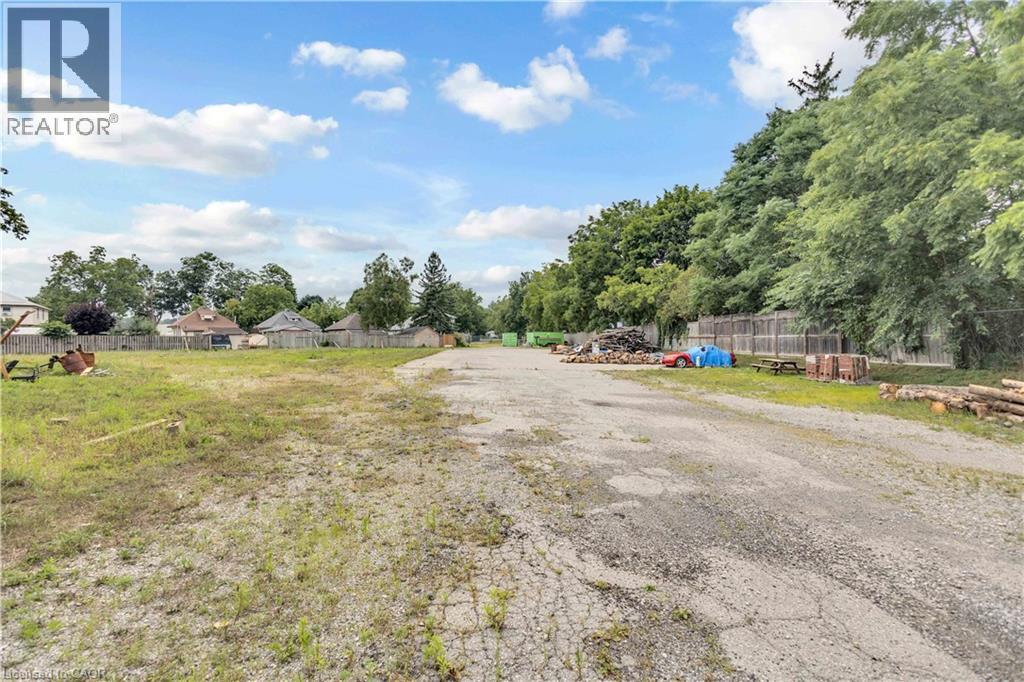 Expansive open lot featuring a combination of gravel and grassy areas - 9 James Street, Simcoe, ON