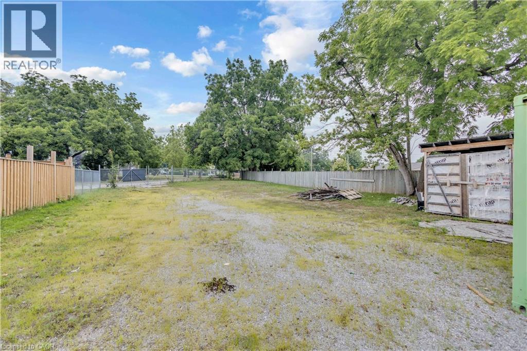 Expansive lot featuring a combination of gravel and grassy areas - 9 James Street, Simcoe, ON