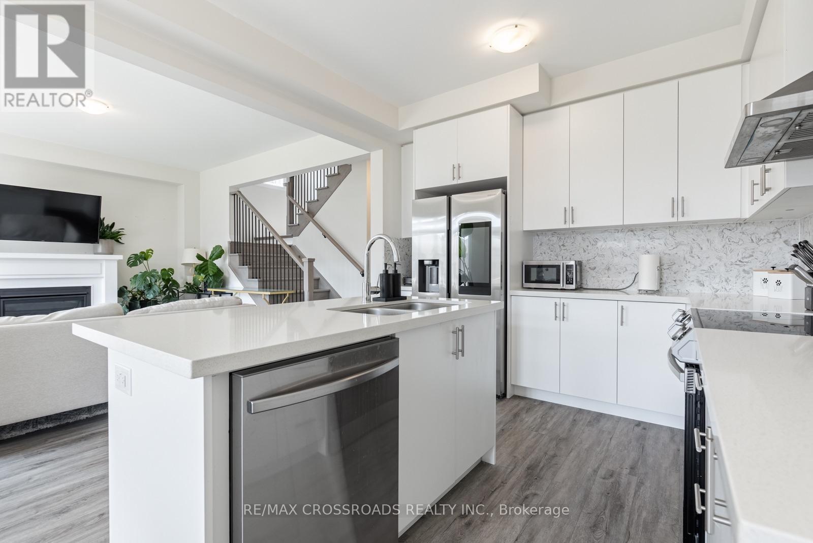 47 Ed Ewert Avenue, Clarington, ON - Indoor Photo Showing Kitchen With Fireplace With Double Sink