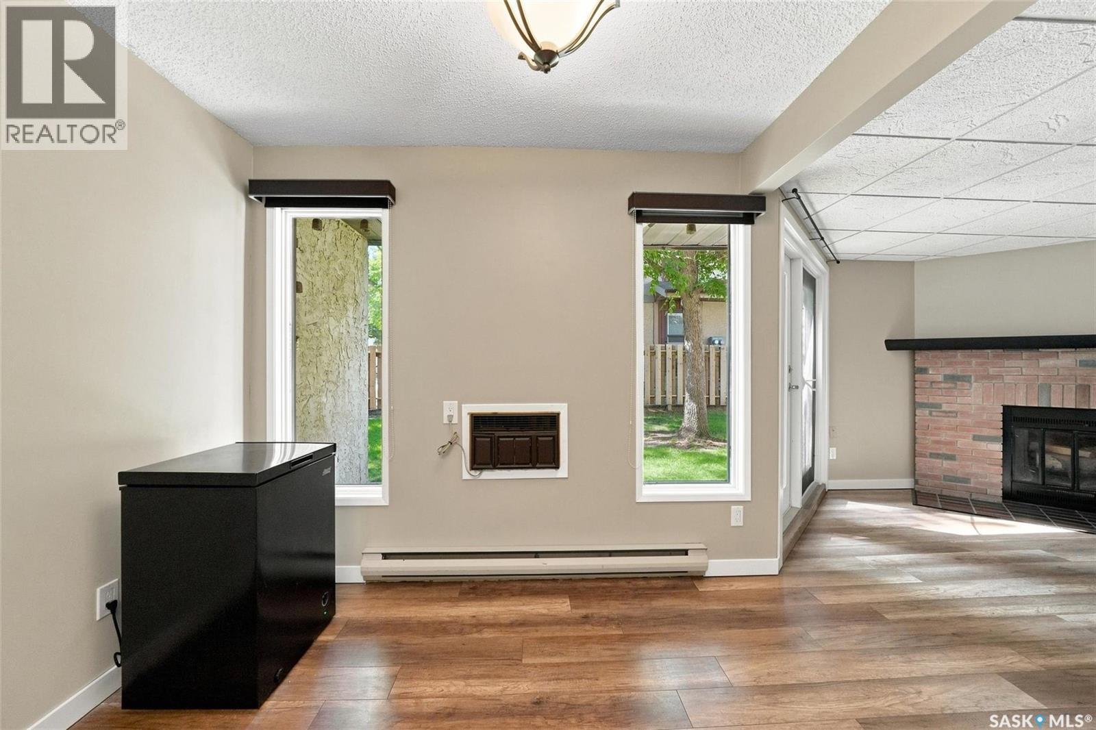 102 431 Tait Court, Saskatoon, SK - Indoor Photo Showing Other Room With Fireplace