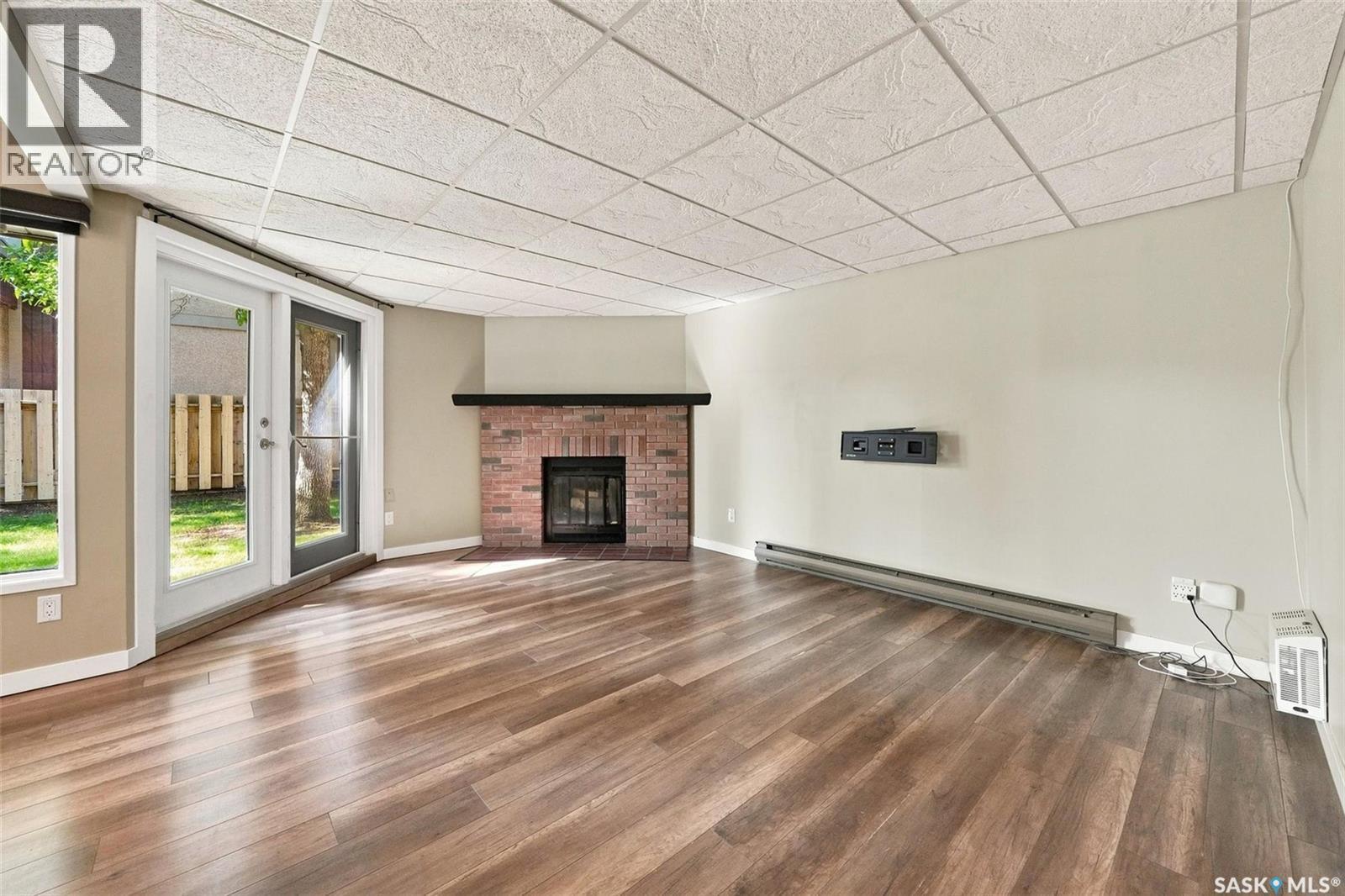 102 431 Tait Court, Saskatoon, SK - Indoor Photo Showing Living Room With Fireplace