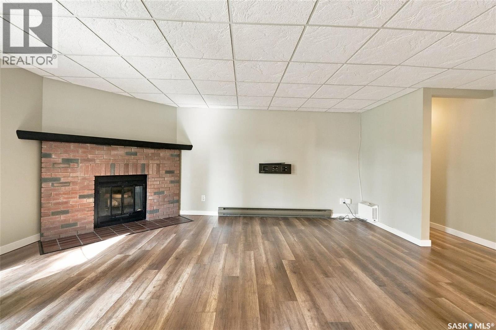 102 431 Tait Court, Saskatoon, SK - Indoor Photo Showing Living Room With Fireplace