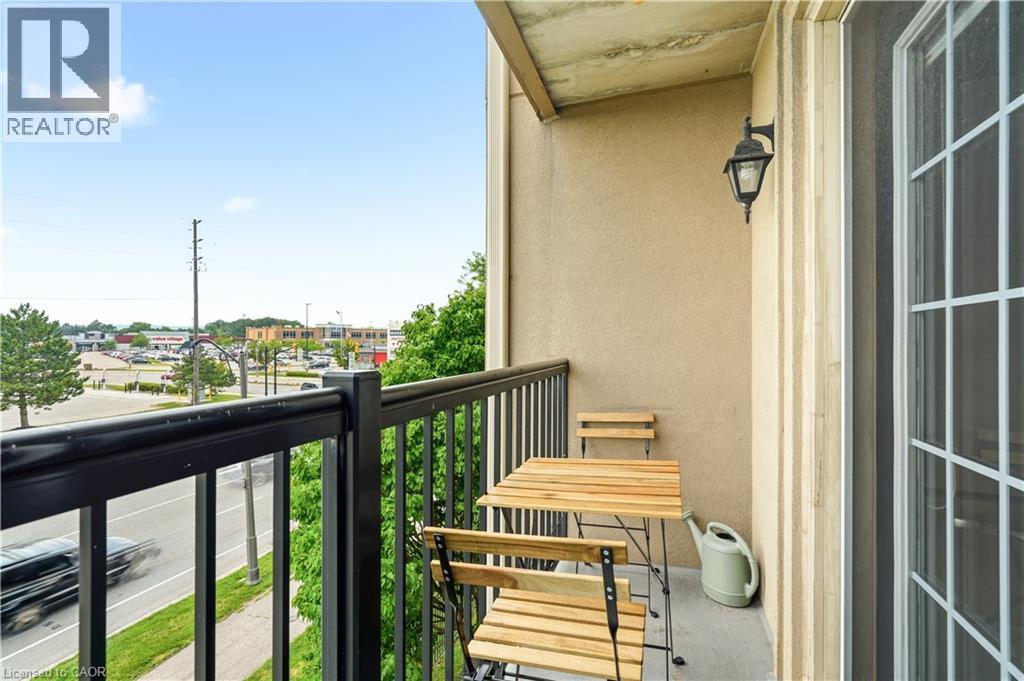 Private balcony featuring a black metal railing and a stucco exterior - 2035 Appleby Line Unit# 307, Burlington, ON - Outdoor With Balcony With Exterior