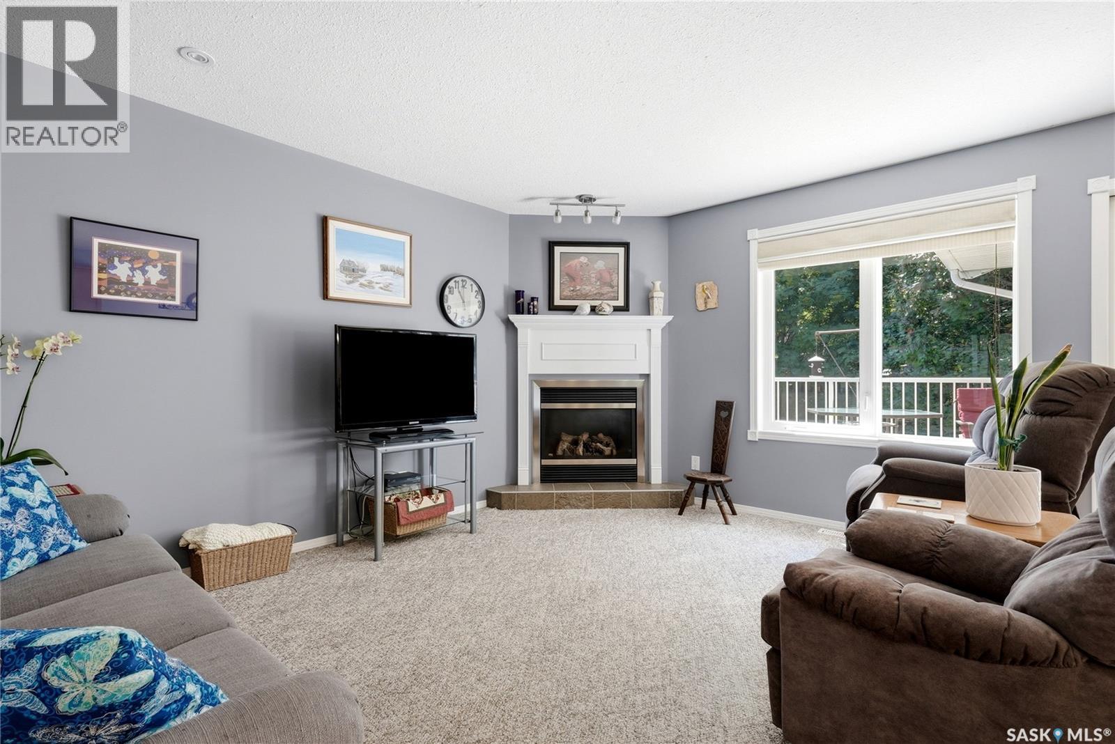 28 Rosedale Avenue, Katepwa Beach, SK - Indoor Photo Showing Living Room With Fireplace