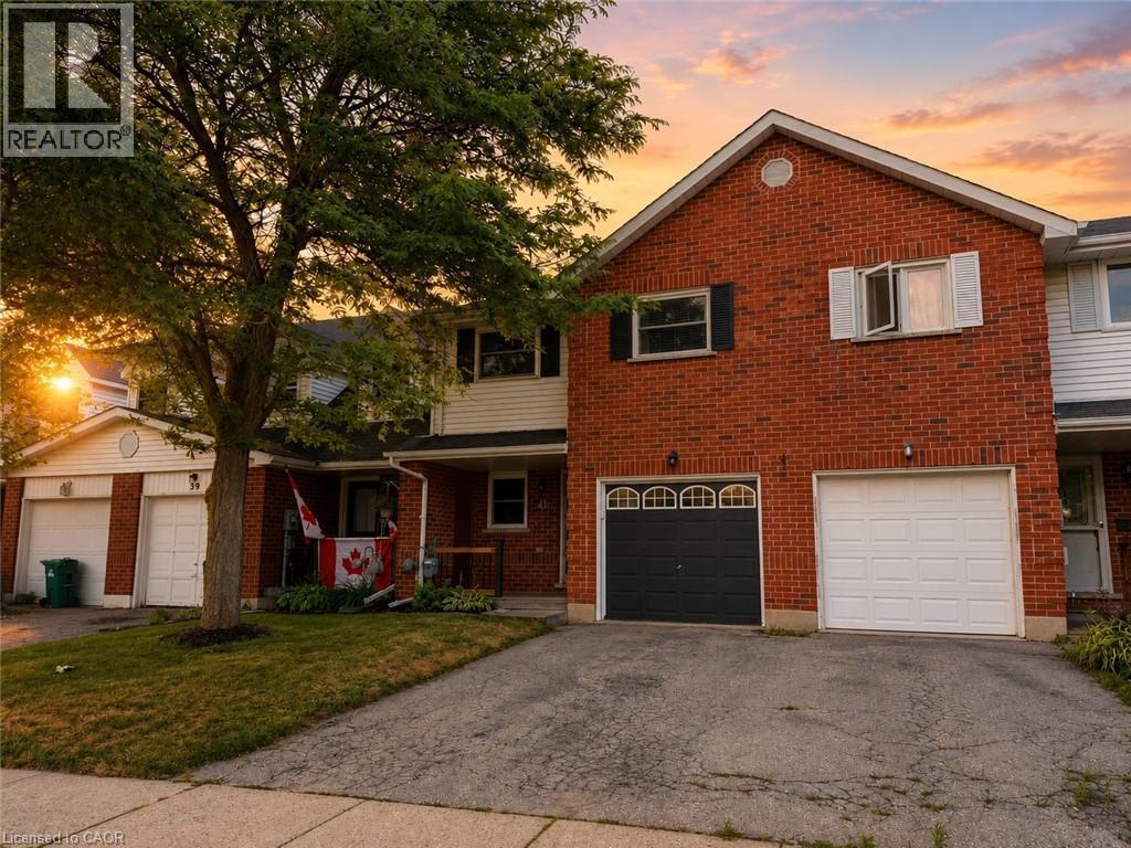 Brick facade home with two garage doors, one in white and one in black - 41 Edgemere Drive, Cambridge, ON - Outdoor