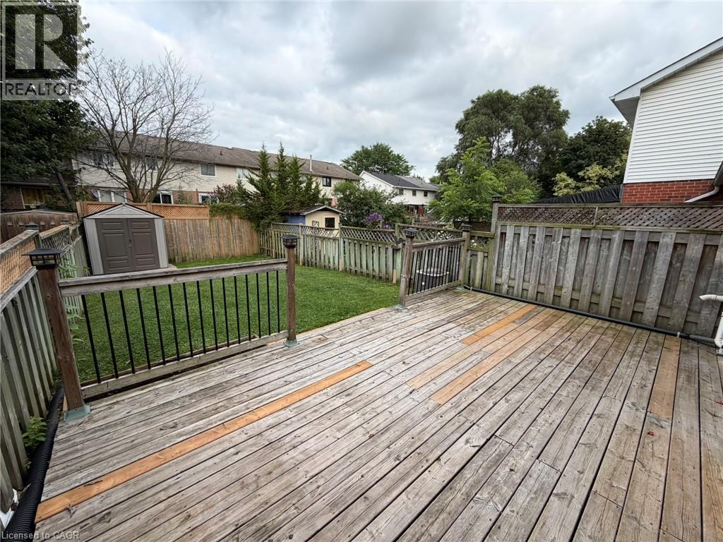 Spacious wood-finish deck with black metal balusters and post-top lighting - 41 Edgemere Drive, Cambridge, ON - Outdoor With Deck Patio Veranda With Exterior